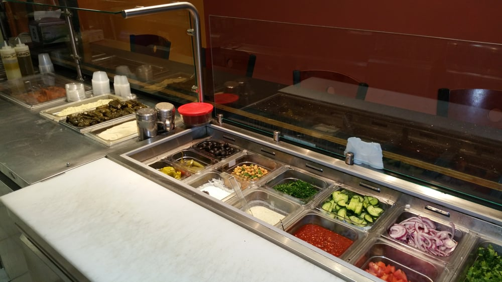 Fresh vegetables, sauces and toppings at the Al Basha Grill counter