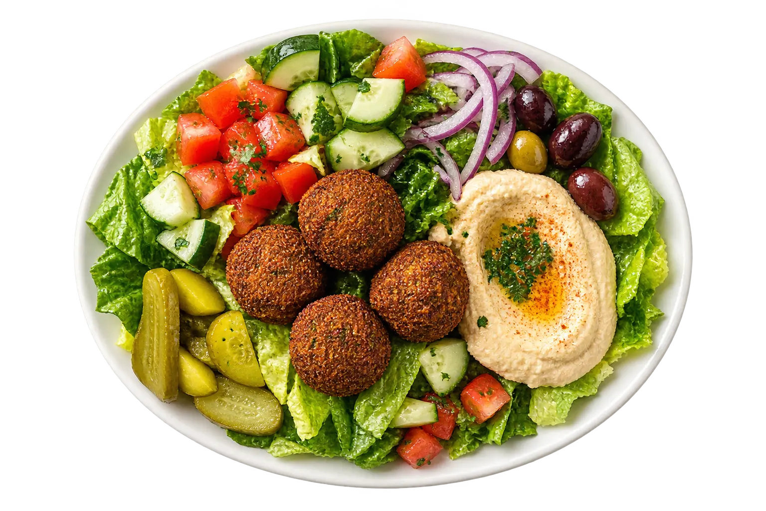 Falafel platter on a white plate with house salad, pickles, olives and hummus